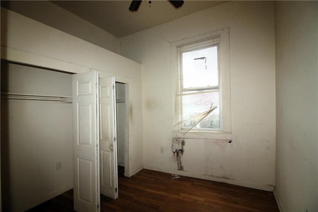 unfurnished bedroom featuring dark hardwood / wood-style floors and ceiling fan