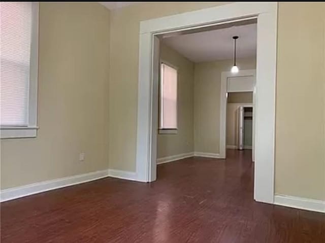 spare room with dark wood-type flooring