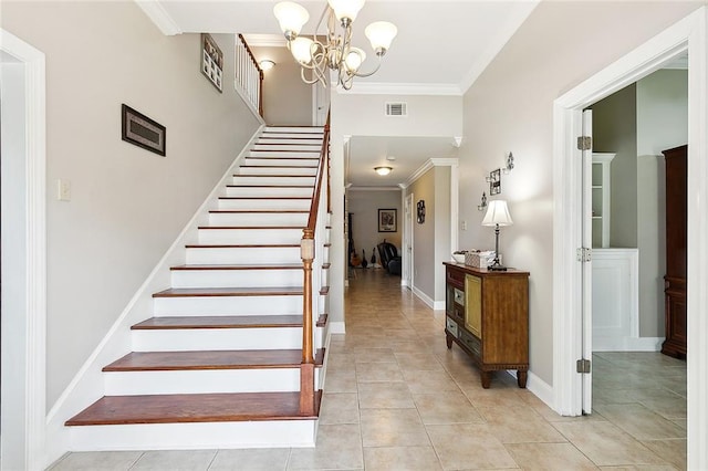 stairs with crown molding, an inviting chandelier, and tile patterned floors