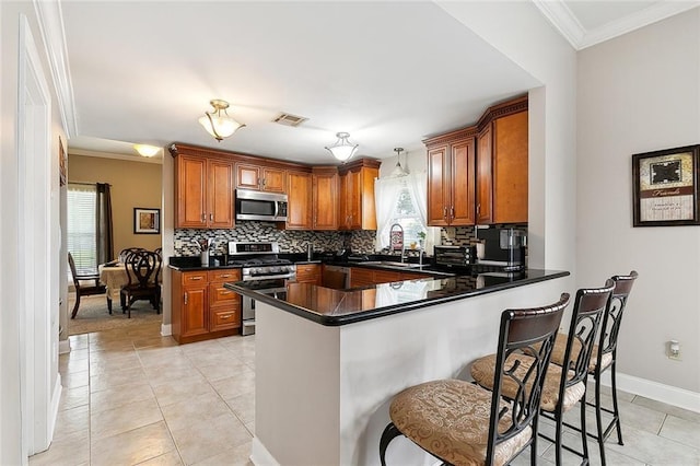 kitchen featuring stainless steel appliances, kitchen peninsula, and light tile patterned flooring