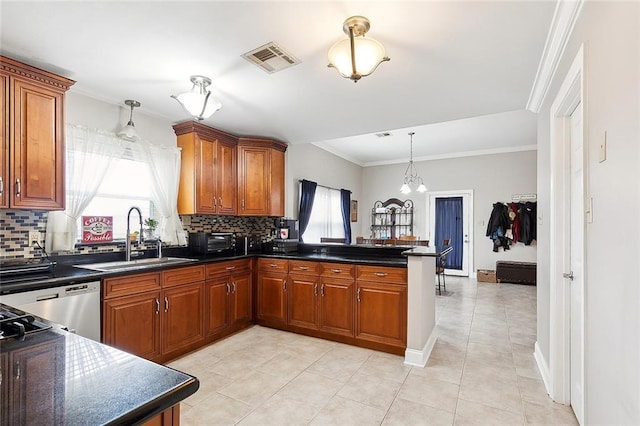 kitchen featuring sink, dishwasher, a chandelier, and decorative backsplash