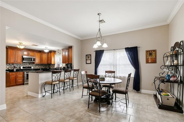 dining room with light tile patterned floors, ornamental molding, and a chandelier