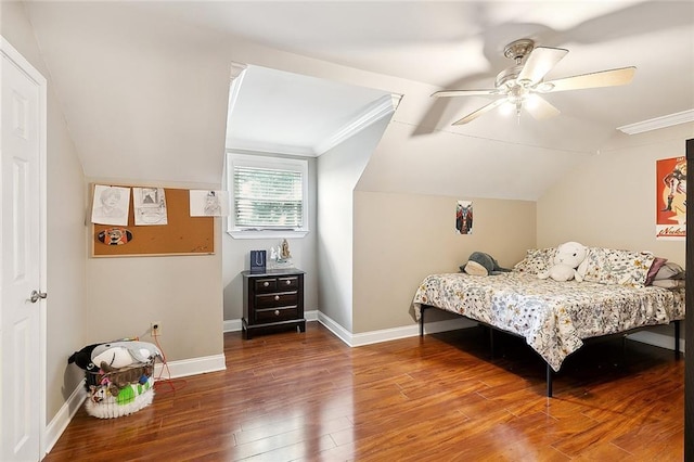 bedroom with hardwood / wood-style flooring, vaulted ceiling, ceiling fan, and ornamental molding