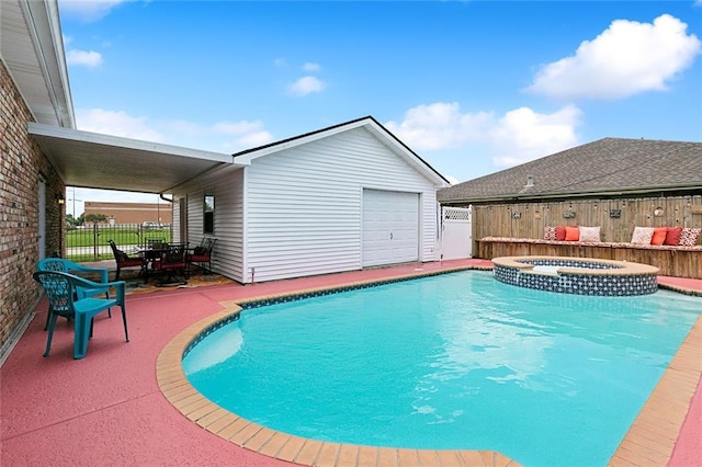 view of swimming pool featuring an in ground hot tub and a patio