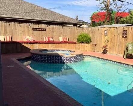 view of pool with an in ground hot tub