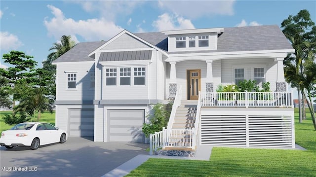 view of front of house featuring covered porch, a garage, and a front lawn