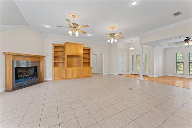 unfurnished living room with light tile patterned floors, a fireplace, and crown molding