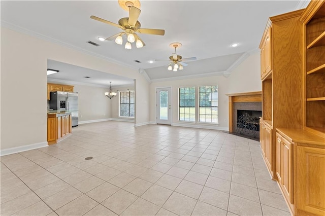 unfurnished living room with light tile patterned floors, visible vents, baseboards, ornamental molding, and a fireplace