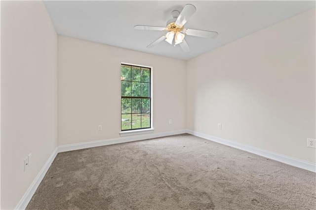 unfurnished room featuring carpet floors, baseboards, and a ceiling fan