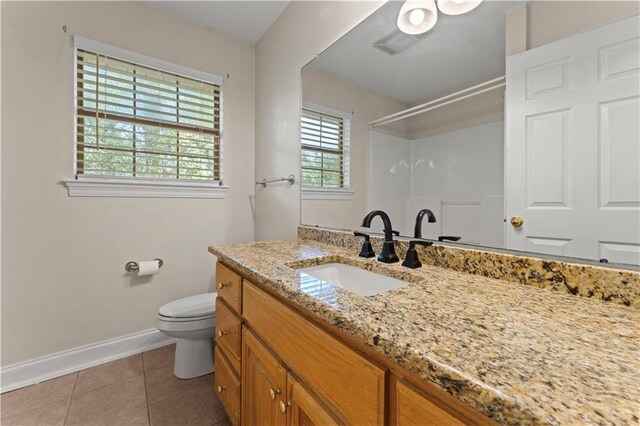 full bath featuring toilet, vanity, baseboards, a shower, and tile patterned floors