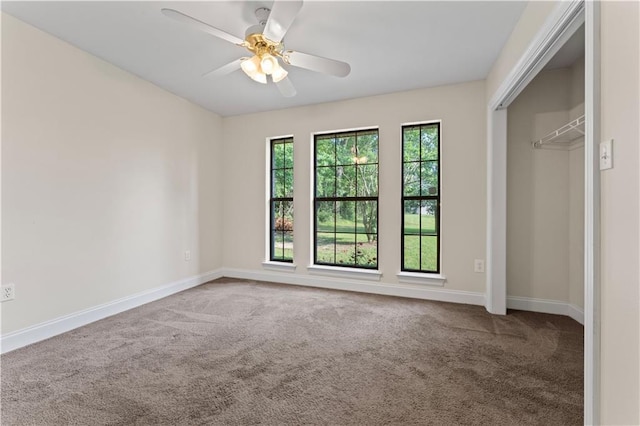 unfurnished bedroom with carpet floors, a closet, baseboards, and a ceiling fan