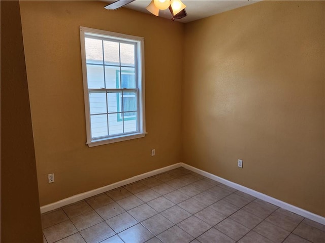 tiled spare room with ceiling fan