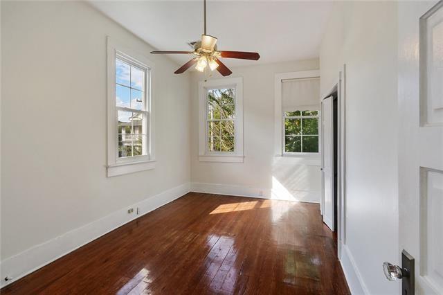 spare room with ceiling fan and dark hardwood / wood-style flooring