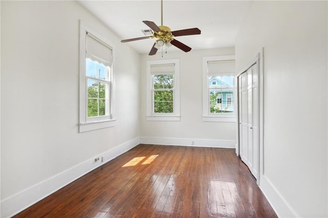 empty room featuring dark wood-type flooring and ceiling fan