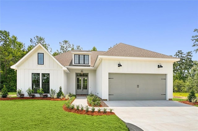 view of front of house with a garage and a front yard