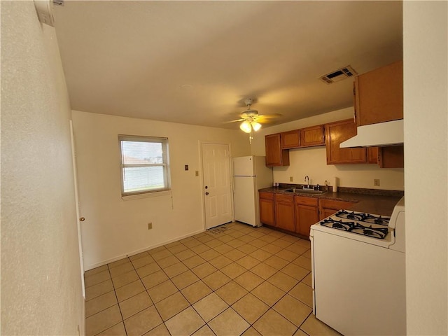 kitchen featuring ceiling fan, light tile patterned flooring, white appliances, and sink