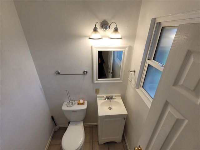 bathroom featuring tile patterned floors, vanity, and toilet