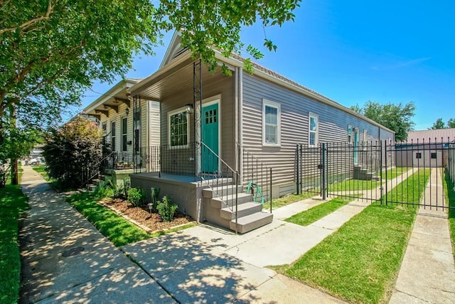 view of front of property with a fenced front yard and a gate