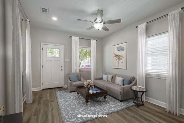 sitting room featuring dark wood-type flooring, visible vents, and baseboards