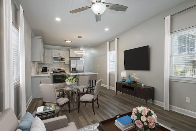 interior space featuring baseboards, dark wood finished floors, a ceiling fan, and recessed lighting