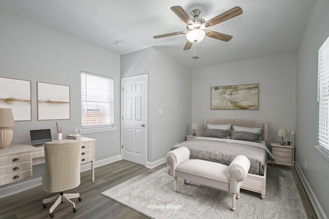 bedroom featuring dark wood-type flooring, baseboards, and a ceiling fan