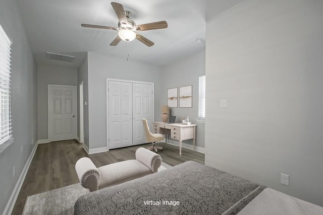 bedroom with ceiling fan, visible vents, baseboards, a closet, and dark wood finished floors