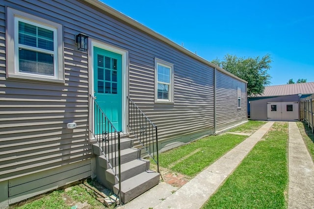 view of home's exterior featuring entry steps and an outdoor structure