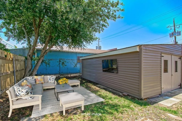 exterior space with an outbuilding, a fenced backyard, and an outdoor living space