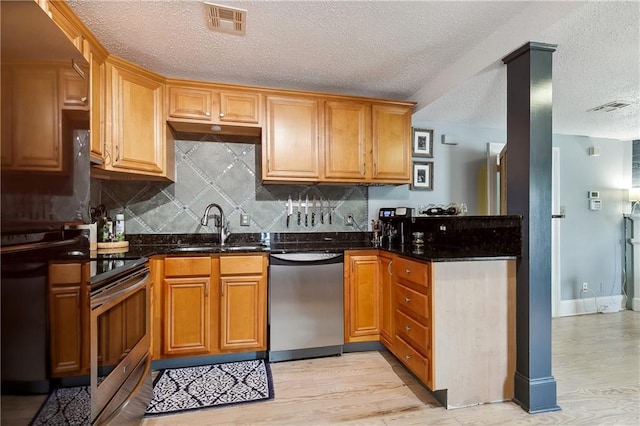 kitchen with light hardwood / wood-style flooring, stainless steel dishwasher, electric stove, dark stone countertops, and sink