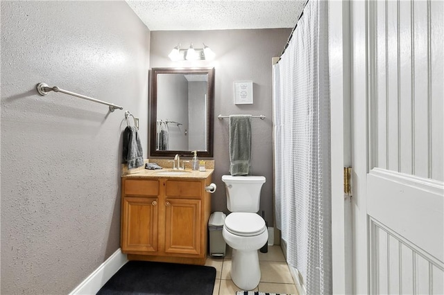 bathroom with a textured ceiling, vanity, toilet, and tile floors