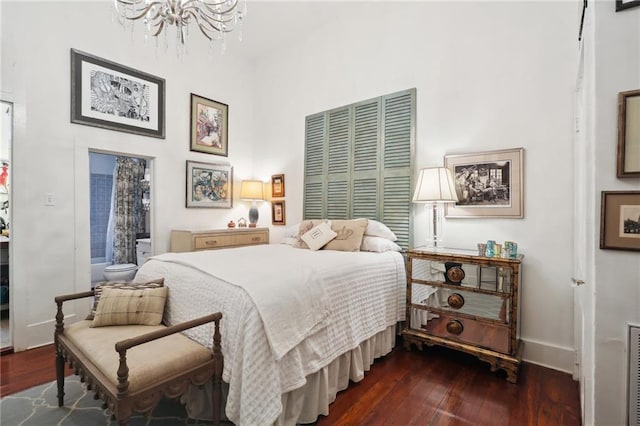 bedroom featuring hardwood / wood-style floors, a chandelier, and a closet