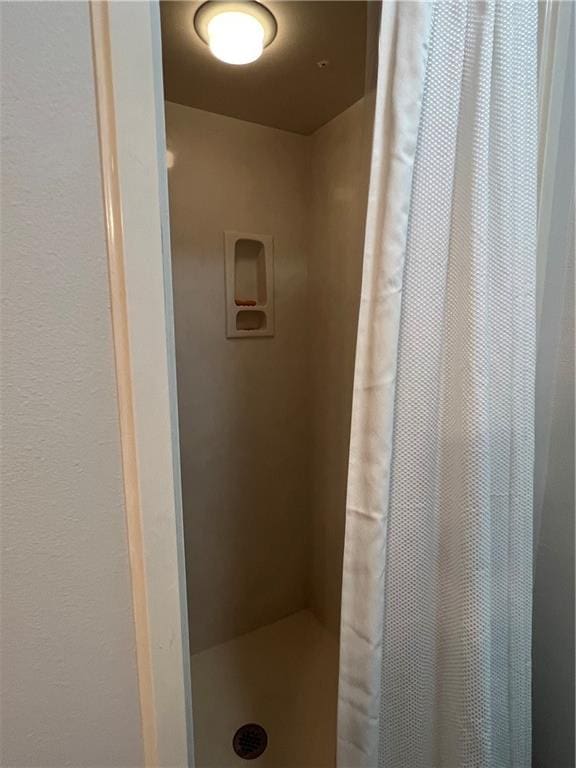 bathroom featuring a shower with curtain