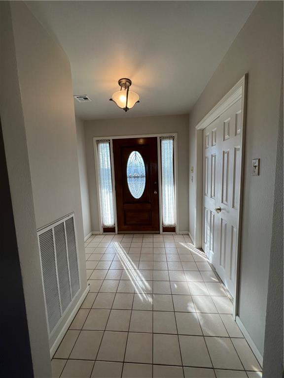 foyer entrance with light tile floors