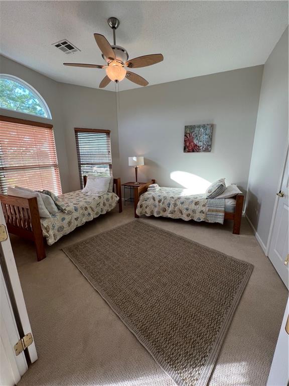 carpeted bedroom featuring ceiling fan