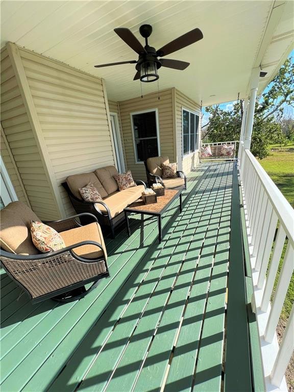 balcony featuring ceiling fan and an outdoor living space