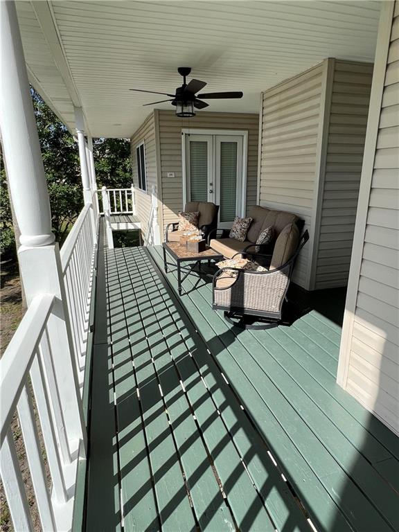 deck featuring outdoor lounge area and ceiling fan