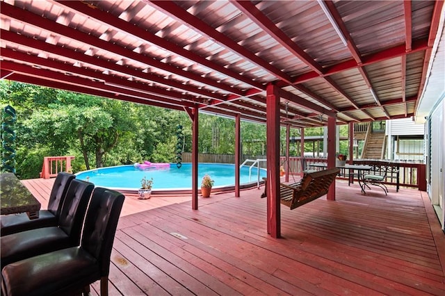 deck with an outdoor pool and stairs