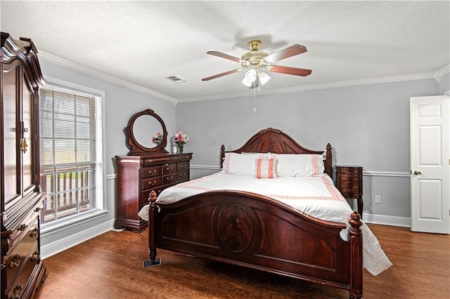 bedroom featuring baseboards, wood finished floors, and a textured ceiling