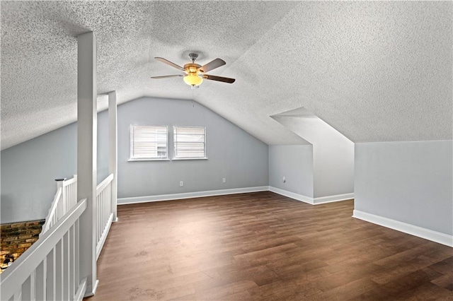 bonus room featuring lofted ceiling, a ceiling fan, wood finished floors, and baseboards