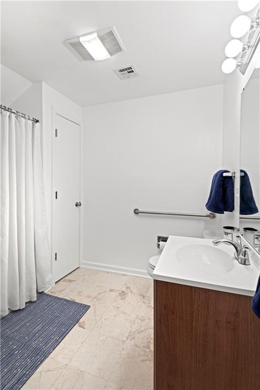full bath with visible vents, marble finish floor, vanity, and toilet
