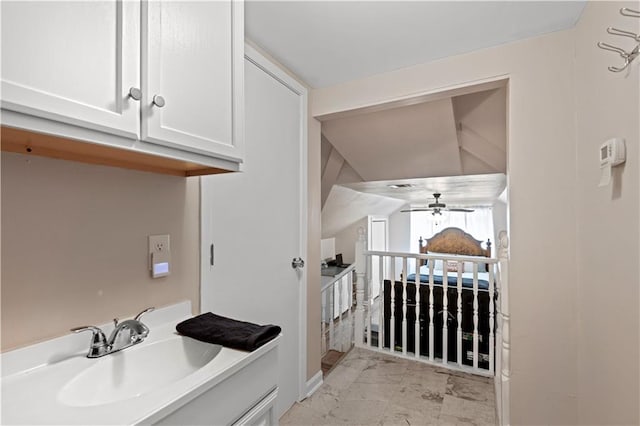 bathroom featuring tile floors, ceiling fan, vaulted ceiling, and vanity