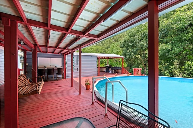 view of swimming pool with a wooden deck and a gazebo