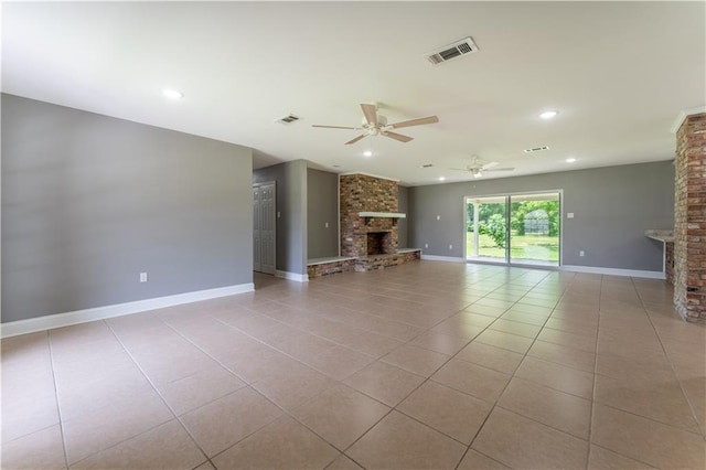 unfurnished living room with ceiling fan, light tile patterned flooring, and a fireplace