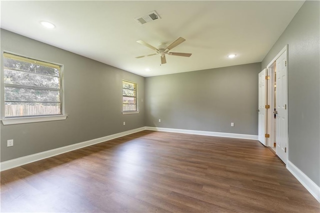 empty room featuring ceiling fan and dark hardwood / wood-style floors