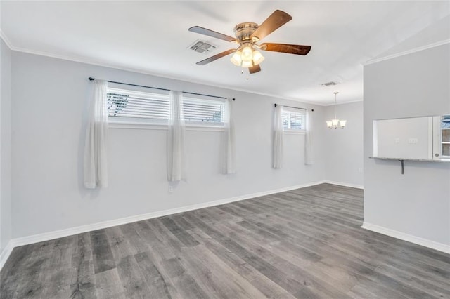 empty room featuring crown molding, ceiling fan with notable chandelier, and dark hardwood / wood-style flooring