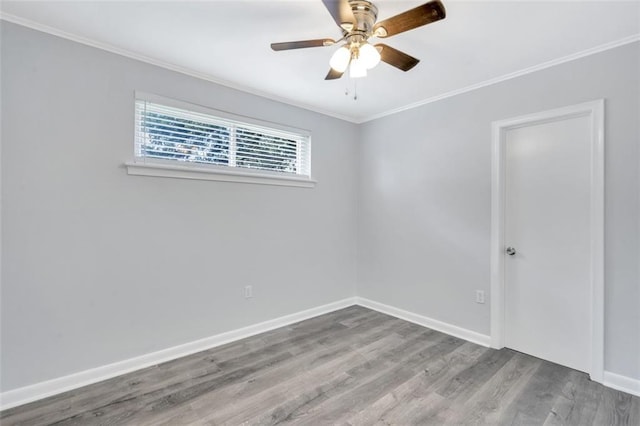 empty room with ceiling fan, hardwood / wood-style flooring, and crown molding