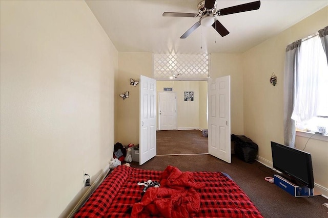 bedroom featuring dark colored carpet and ceiling fan