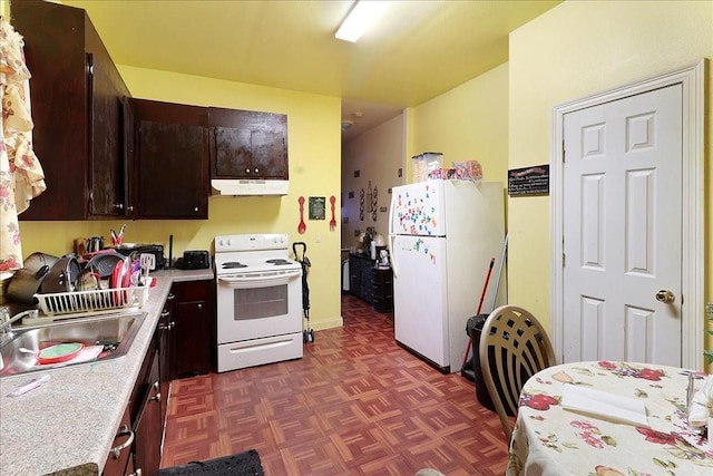 kitchen with dark brown cabinets, white appliances, sink, and dark parquet floors