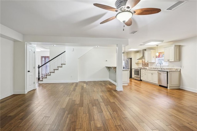 205 Stonehaven Dr, Belle Chasse, LA 70037 - unfurnished living room with ceiling fan, light hardwood / wood-style floors, and sink