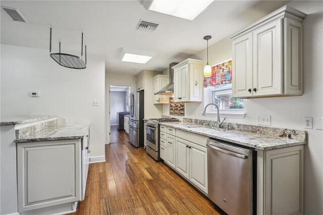 205 Stonehaven Dr, Belle Chasse, LA 70037 - kitchen with a skylight, sink, dark hardwood / wood-style floors, decorative light fixtures, and appliances with stainless steel finishes